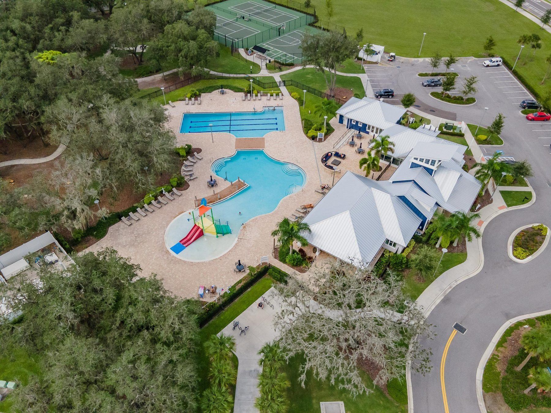 Triple Creek amenity center with pool, splash area, and courts